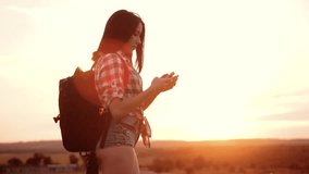 Hipster hiker silhouette girl wanderer search position navigation on mobile phone smartphone to find right way during slow motion video adventure nature travel. woman hiker checks weather forecast via