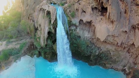 Small cave and waterfall on Havasu Creek at autumn sunny day in Grand Canyon. Aerial view