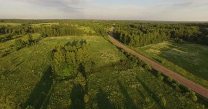 4K high quality sunny summer sunset early evening video of green fields and forests near picturesque Gorki village, rural road near Pereslavl-Zalesskiy on Golden Ring route 120 km from Moscow, Russia