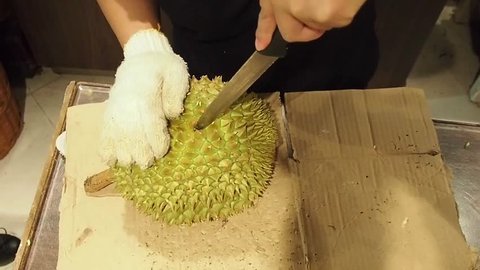 Asian traders are peeling durian.