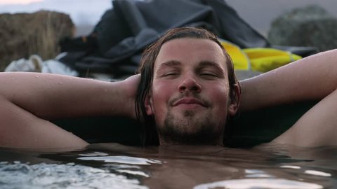 Man in geothermal hot pool in Iceland
