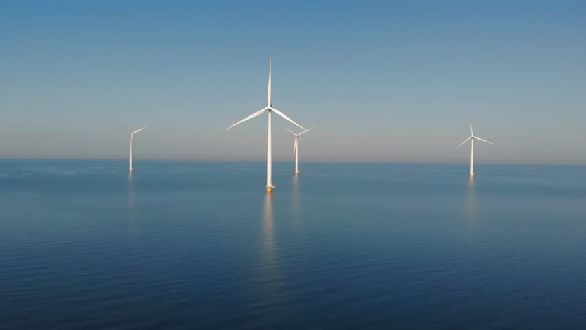 Offshore Windmill farm in the ocean  Westermeerwind park , windmill green energy at sea on a beautiful bright day Netherlands Flevoland  | Shutterstock HD Video #1012563842