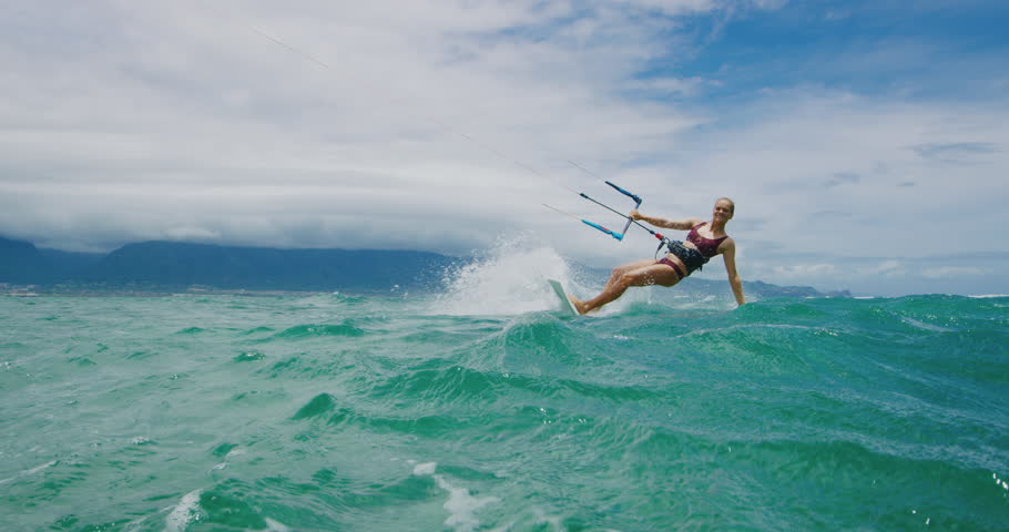 Beautiful young woman kitesurfing, extreme sport slow motion | Shutterstock HD Video #1012564235