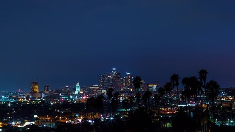 Sunrise time-lapse of Downtown Los Angeles with palm trees