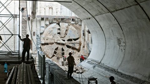 Tunnel boring machine moving across subway station under construction