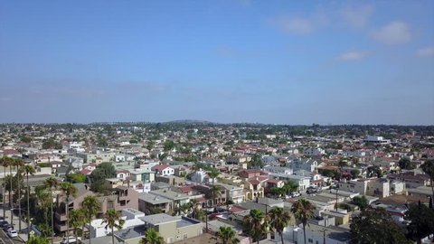 Aerial drone footage of ascending over the Belmont Shore section of Long Beach, California with Signal Hill in the background