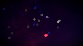 Cinematic loop 4k video of defocused fireworks display trails at national holiday in blue, red and white colors