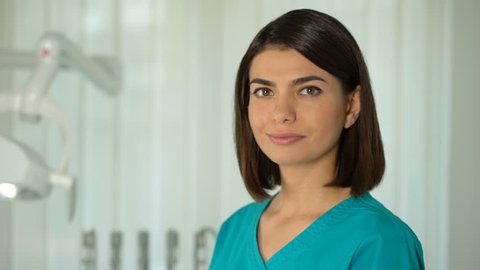 Charming female doctor posing for camera, confidence and professionalism, clinic