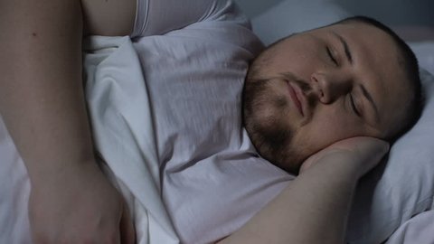 Chubby man snoring during night time, sleeping disorder caused by overweight