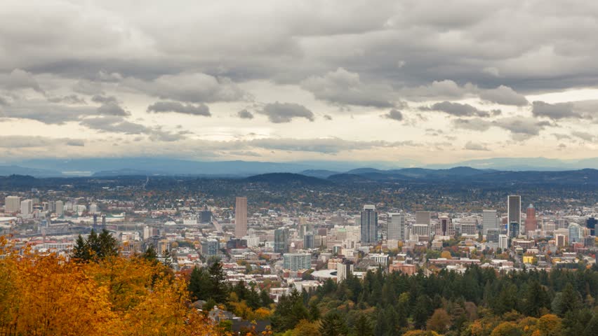 Time lapse video of moving clouds and sky over Portland Oregon downtown cityscape in beautiful Pacific Northwest colorful fall season 4k ultra hd