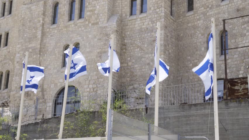 Israeli flags fly near the western wall in old city Jerusalem. 
