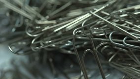 Metal paper clips stacked up extreme closeup, office supplies, unorganized group