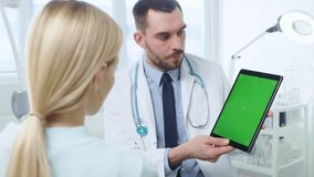 Over the Shoulder Shot of a Female Patient Talking with a Professional Doctor Who Show Her Digital Tablet Computer with Mock-up Green Screen. Shot on RED EPIC-W 8K Helium Cinema Camera. - Powered by Shutterstock - Get 15% off with code: PIKWIZARD15