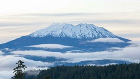 Ultra high definition time lapse video of white moving clouds over snow covered Mt St Helens in Washington state 4k UHD