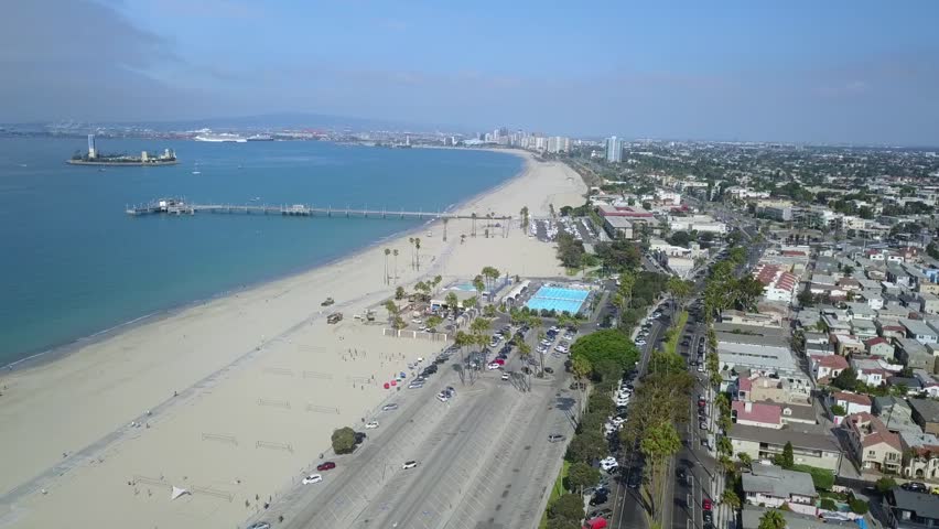 Sideways pan of the Belmont Pier in Long Beach California. Including the Belmont Pool, used in the 1984 Olympics, downtown Long Beach skyline and Palos Verdes Peninsula in the background.