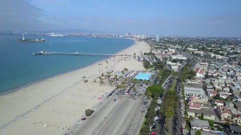 Sideways pan of the Belmont Pier in Long Beach California. Including the Belmont Pool, used in the 1984 Olympics, downtown Long Beach skyline and Palos Verdes Peninsula in the background.