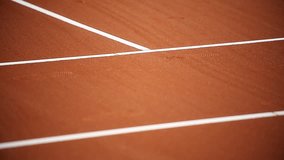 Detail with sport shoe footprints on a tennis clay court