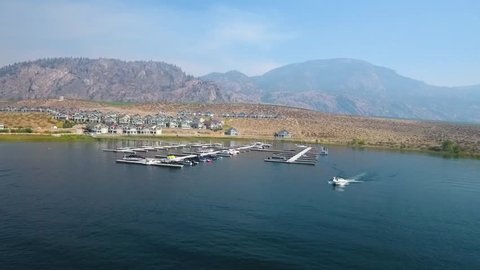 beautiful perspective of Osoyoos cottages with boat, lake and mountain landscape