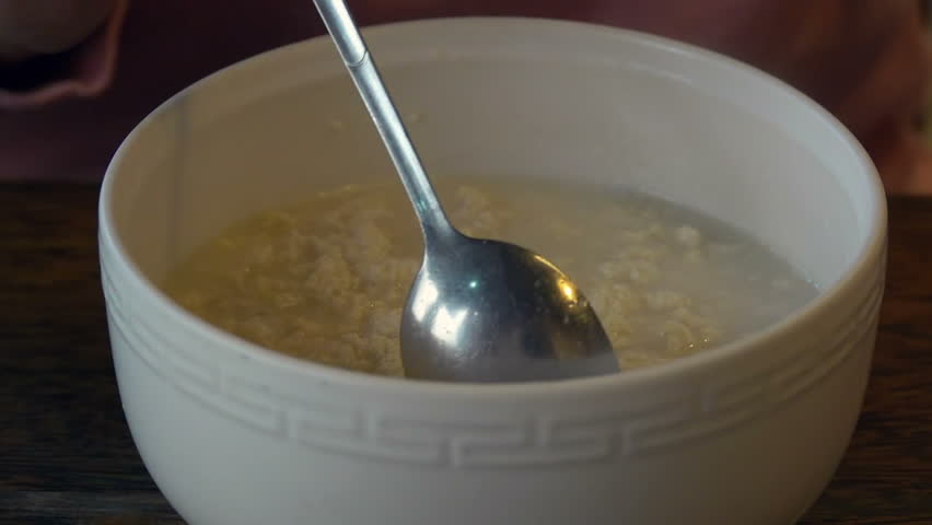 Stirring Tofu Cereal with Spoon. Healthy Vegeterian Asian Food. Close Up View