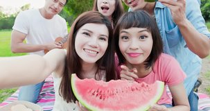 people selfie happily and eat watermelon enjoy at a picnic