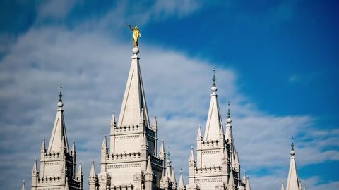 Long exposure time lapse of the upper steeples of the Mormon LDS Temple in Salt Lake City, Utah with silky smooth clouds passing by