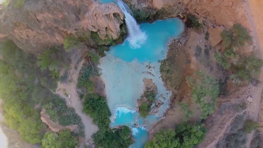 Grand Canyon with waterfall Havasu Falls at autumn sunny day. Aerial view in timelapse