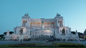 Evening Piazza Venezia view across street no camera movement of lighted Altar of the Fatherland, Il Vittoriano monument in Rome, Italy. 4K UHD at 25fps