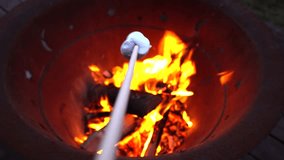 Two People Roasting Marshmallows over a Fire Pit - Powered by Shutterstock - Get 15% off with code: PIKWIZARD15