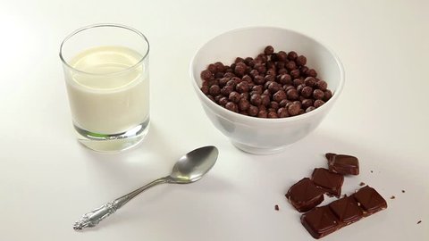 Milk breakfast, chocolate, milk pouring, chocolate balls, a glass of milk.