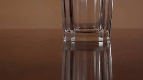 Pouring hot water to the glass with sachet of herbal tea added in the end. 4K resolution pedestal movement