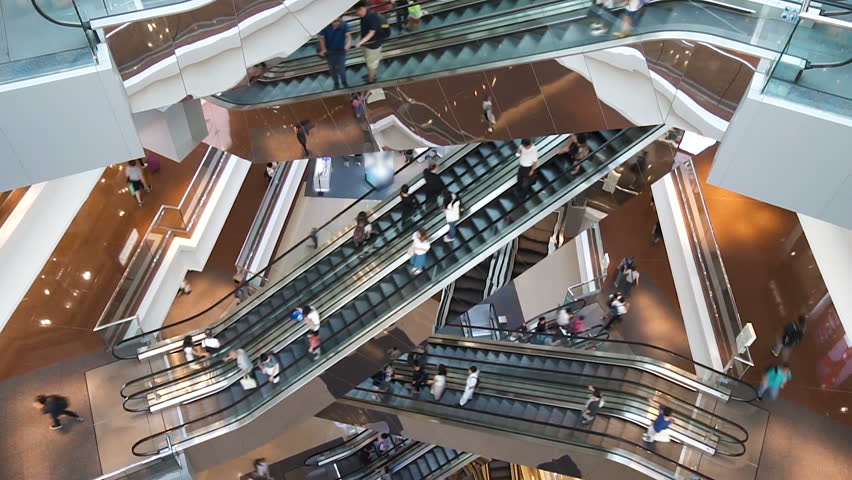 HONG KONG, CHINA - CIRCA JUNE , 2018: Time lapse escalators in modern shopping mall crowd of people. Very busy full of clients mall complex.  | Shutterstock HD Video #1012641929