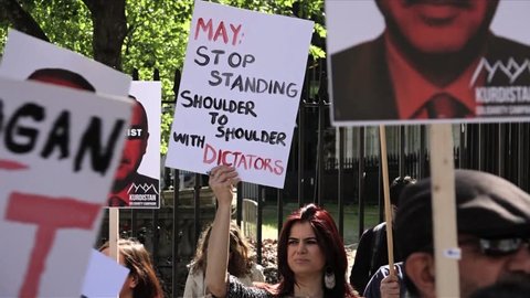 London, United Kingdom (UK) - 05 14 2018: Protestor holds a placard denouncing UK prime minister and Turkish president
