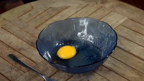 video footage hand chicken egg shaking at glass bowl