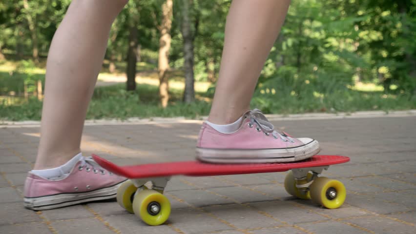 Female legs riding on skateboard in park, asian female hipster on skate and holding backpack | Shutterstock HD Video #1012655141