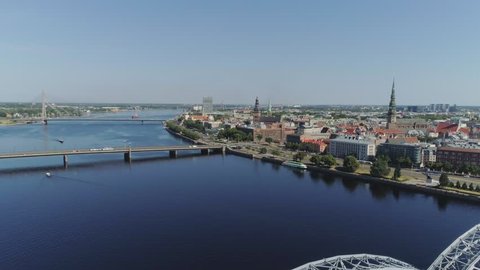 Slowmotion Riga City Bridges drone Flight Old town air flight with buildings and cars near daugava river and Library