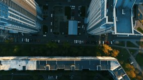 High angle view. The camera flies above the roof of the skyscraper at sunset. Spring. Aerial footage. 4K