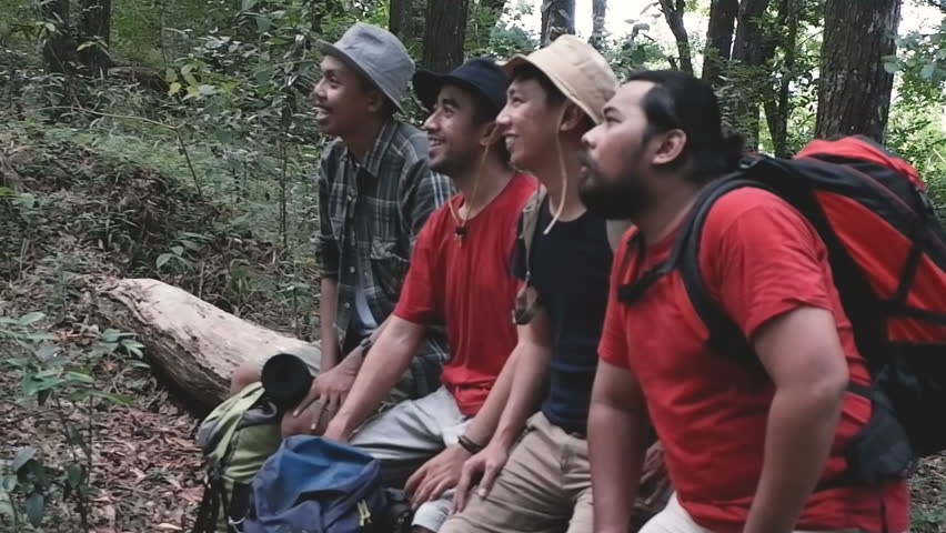 group of asian hiker sitting and pointing somewhere