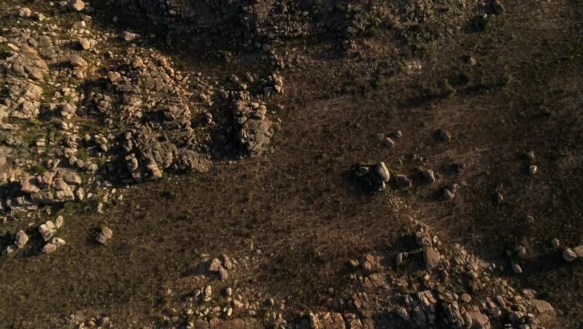 Top down aerial shot flying over rocky terrain in South Africa