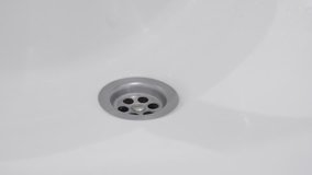 Spraying bathroom sink drain hole slow-mo video
