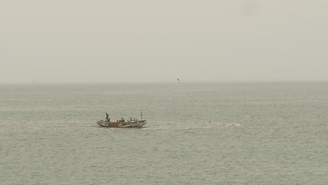Long shot of fishermen at sea. Senegal, Africa.