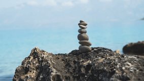 Balance of stones against the background of the sea. 4k