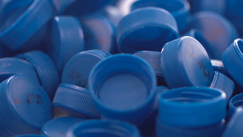 Blue plastic bottle caps. Studio shot. Plastic waste. x5 slow motion. | Shutterstock HD Video #1012692224