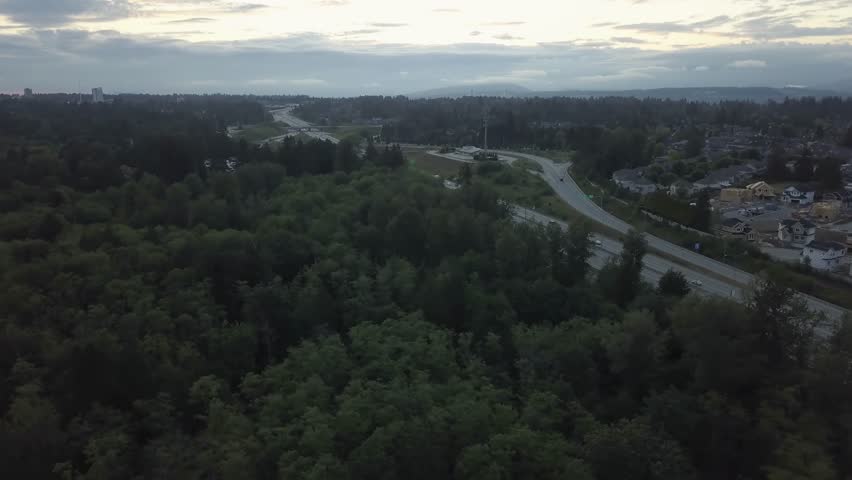 Aerial view of the Trans Canada Highway during a cloudy sunset. Taken in Surrey, Greater Vancouver, British Columbia, Canada.