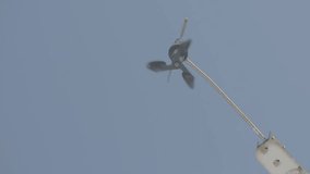 Slow motion shot of windmill in the sky.The concept of wind energy, - Powered by Shutterstock - Get 15% off with code: PIKWIZARD15