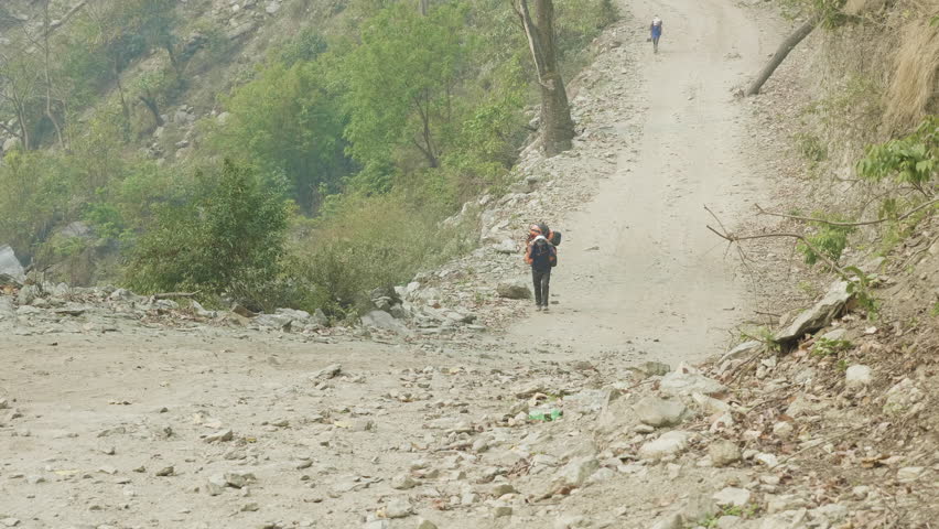 Porters with the heavy backpacks on the Manaslu mountain circuit trek in Nepal.