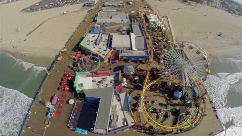 SANTA MONICA - OCT 19, 2014: Amusement park on Santa Monica Pier at autumn sunny day. Aerial view. Pier was opened in 1909.
