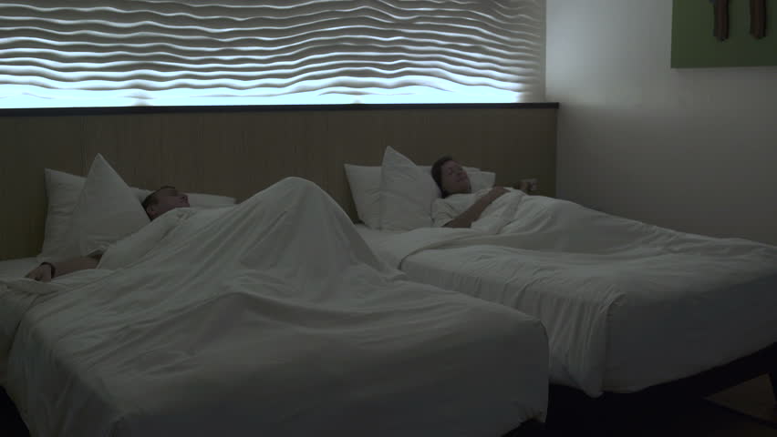 A man and a woman are awake in the room and stand up Royalty-Free Stock Footage #1012700582