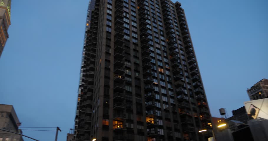 A right-to-left panning shot to the Metropolitan Life Insurance Company Tower near Madison Square Park at dusk.  	