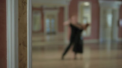 Reflection in the mirror of a couple dancing a passionate dance