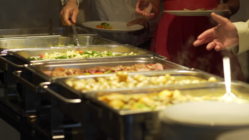 Restaurant guests select food from a buffet. Royalty-Free Stock Footage #1012710962